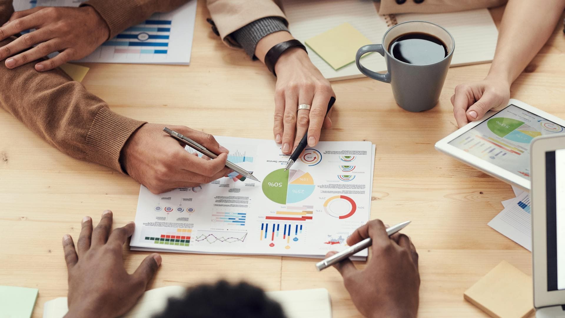People collaborating over laptops in an office β illustrative stock photo.